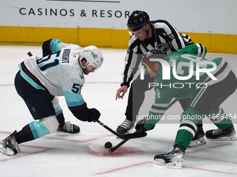 Roope Hintz #24 of the Dallas Stars and Shane Wright #51 of the Seattle Kraken line up against one another during the NHL match between the...