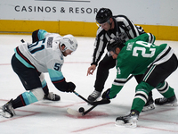 Roope Hintz #24 of the Dallas Stars and Shane Wright #51 of the Seattle Kraken line up against one another during the NHL match between the...