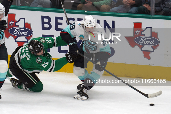 Jared McCann #19 of the Seattle Kraken is defended by Jason Robertson #21 of the Dallas Stars during the NHL match between the Dallas Stars...