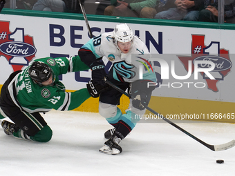 Jared McCann #19 of the Seattle Kraken is defended by Jason Robertson #21 of the Dallas Stars during the NHL match between the Dallas Stars...