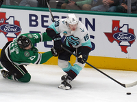 Jared McCann #19 of the Seattle Kraken is defended by Jason Robertson #21 of the Dallas Stars during the NHL match between the Dallas Stars...