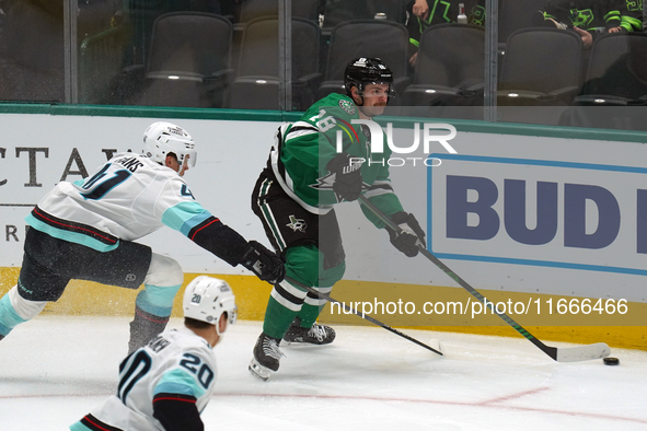 Sam Steel #18 of the Dallas Stars and Ryker Evans #41 of the Seattle Kraken skate on the ice while battling for the puck during the NHL matc...