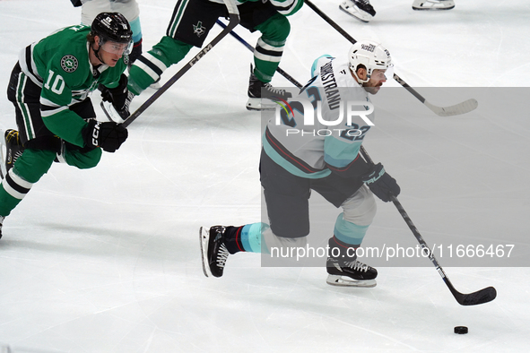 Oliver Bjorkstrand #22 of the Seattle Kraken skates on the ice while controlling the puck during the NHL match between the Dallas Stars and...