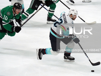 Oliver Bjorkstrand #22 of the Seattle Kraken skates on the ice while controlling the puck during the NHL match between the Dallas Stars and...