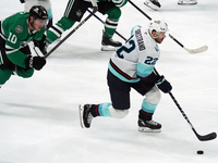 Oliver Bjorkstrand #22 of the Seattle Kraken skates on the ice while controlling the puck during the NHL match between the Dallas Stars and...