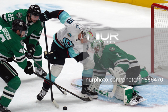 Casey DeSmith, the #1 goalkeeper of the Dallas Stars, tries to stop the shot of Carson Rehkopf, #19 of the Seattle Kraken, during the NHL ma...