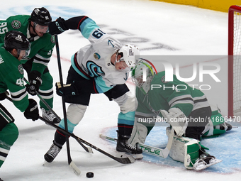 Casey DeSmith, the #1 goalkeeper of the Dallas Stars, tries to stop the shot of Carson Rehkopf, #19 of the Seattle Kraken, during the NHL ma...