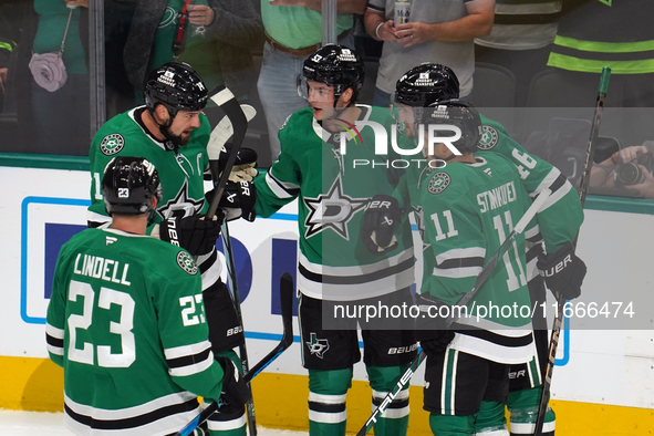 Jamie Benn #14, Esa Lindell #23, Logan Stankoven #11, and Ilya Lyubushkin #46 of the Dallas Stars join on the ice during the NHL match betwe...