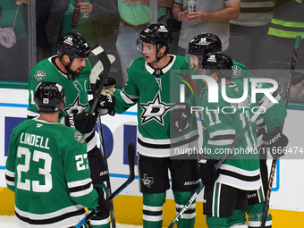 Jamie Benn #14, Esa Lindell #23, Logan Stankoven #11, and Ilya Lyubushkin #46 of the Dallas Stars join on the ice during the NHL match betwe...