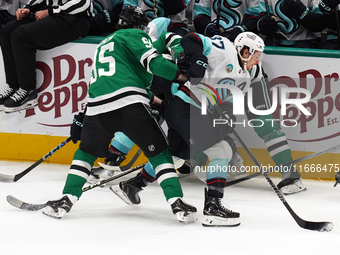 Yanni Gourde #37 of the Seattle Kraken gains possession of the puck after a battle against Dallas Stars players during the NHL match between...