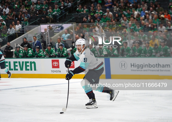 Chandler Stephenson #9 of the Seattle Kraken skates on the ice with the puck during the NHL match between the Dallas Stars and the Seattle K...