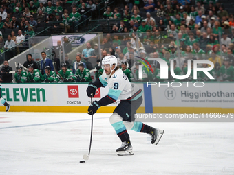 Chandler Stephenson #9 of the Seattle Kraken skates on the ice with the puck during the NHL match between the Dallas Stars and the Seattle K...