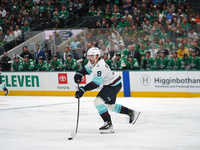 Chandler Stephenson #9 of the Seattle Kraken skates on the ice with the puck during the NHL match between the Dallas Stars and the Seattle K...