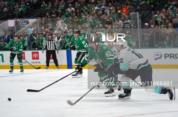 Evgenii Dadonov #63 of the Dallas Stars and Tye Kartye #12 of the Seattle Kraken skate on the ice while battling for the puck during the NHL...