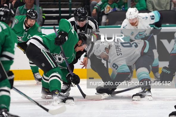 Roope Hintz #24 of the Dallas Stars and Chandler Stephenson #9 of the Seattle Kraken line up against one another during the NHL match betwee...