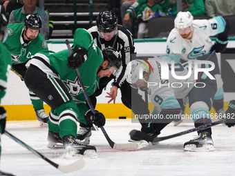 Roope Hintz #24 of the Dallas Stars and Chandler Stephenson #9 of the Seattle Kraken line up against one another during the NHL match betwee...