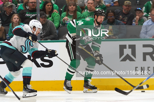 Jamie Benn #14 of the Dallas Stars skates on the ice with the puck during the NHL match between the Dallas Stars and the Seattle Kraken at A...