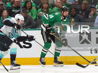 Jamie Benn #14 of the Dallas Stars skates on the ice with the puck during the NHL match between the Dallas Stars and the Seattle Kraken at A...