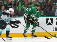 Jamie Benn #14 of the Dallas Stars skates on the ice with the puck during the NHL match between the Dallas Stars and the Seattle Kraken at A...