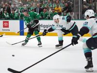 Wyatt Johnston #53 of the Dallas Stars defends the puck against Jamie Oleksiak #24 and Brandon Montour #62 of the Seattle Kraken during the...