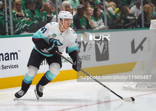 Ryker Evans #41 of the Seattle Kraken slides on the ice to control the puck during the NHL match between the Dallas Stars and the Seattle Kr...