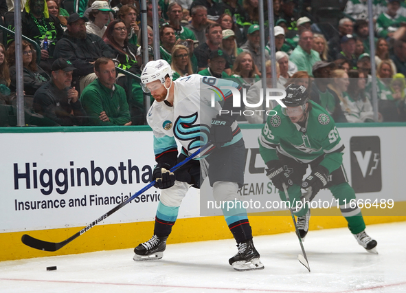 Matt Duchene #95 of the Dallas Stars and Adam Larsson #6 of the Seattle Kraken skate on the ice while battling for the puck during the NHL m...