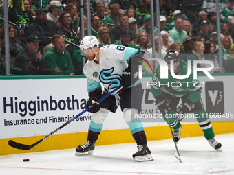 Matt Duchene #95 of the Dallas Stars and Adam Larsson #6 of the Seattle Kraken skate on the ice while battling for the puck during the NHL m...