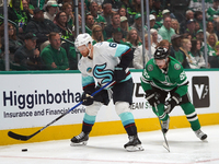 Matt Duchene #95 of the Dallas Stars and Adam Larsson #6 of the Seattle Kraken skate on the ice while battling for the puck during the NHL m...