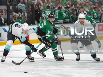 Wyatt Johnston #53 of the Dallas Stars defends the puck against Will Borgen #3 and Jordan Eberle #7 of the Seattle Kraken during the NHL mat...