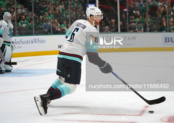 Adam Larsson #6 of the Seattle Kraken skates on the ice with the puck during the NHL match between the Dallas Stars and the Seattle Kraken a...