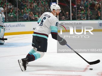 Adam Larsson #6 of the Seattle Kraken skates on the ice with the puck during the NHL match between the Dallas Stars and the Seattle Kraken a...