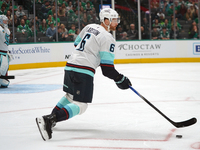 Adam Larsson #6 of the Seattle Kraken skates on the ice with the puck during the NHL match between the Dallas Stars and the Seattle Kraken a...