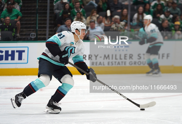 Ryker Evans #41 of the Seattle Kraken skates on the ice with the puck during the NHL match between the Dallas Stars and the Seattle Kraken a...