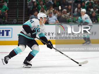 Ryker Evans #41 of the Seattle Kraken skates on the ice with the puck during the NHL match between the Dallas Stars and the Seattle Kraken a...