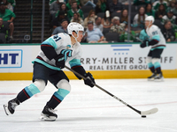 Ryker Evans #41 of the Seattle Kraken skates on the ice with the puck during the NHL match between the Dallas Stars and the Seattle Kraken a...