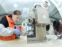 Workers produce new energy commercial vehicle parts at a workshop in Haian, Jiangsu province, China, on October 15, 2024. (