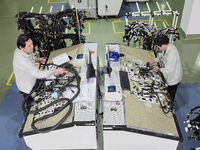 Workers produce new energy commercial vehicle parts at a workshop in Haian, Jiangsu province, China, on October 15, 2024. (