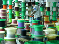 Workers produce new energy commercial vehicle parts at a workshop in Haian, Jiangsu province, China, on October 15, 2024. (