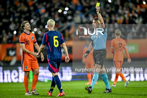 Referee Robert Jones shows a yellow card to Netherlands player Youri Regeer during the match between Netherlands U21 and Sweden U21 at the G...