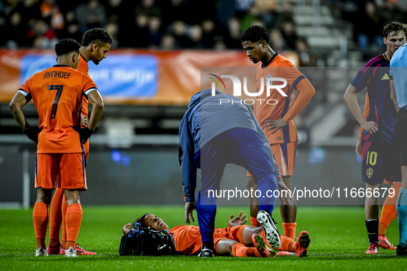 Netherlands player Gjivaj Zechiel lies injured on the ground during the match between Netherlands U21 and Sweden U21 at the Goffertstadion f...