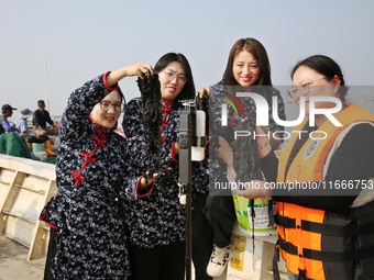 Internet anchors sell fresh laver via live streaming at sea in Lianyungang, China, on October 15, 2024. (