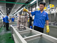 A worker electroplates metal jewelry at a jewelry processing plant in Jinhua, China, on October 15, 2024. (