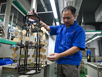 A worker electroplates metal jewelry at a jewelry processing plant in Jinhua, China, on October 15, 2024. (