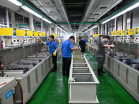 A worker electroplates metal jewelry at a jewelry processing plant in Jinhua, China, on October 15, 2024. (