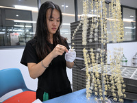 A worker sorts metal ornaments at a jewelry processing plant in Jinhua, China, on October 15, 2024. (