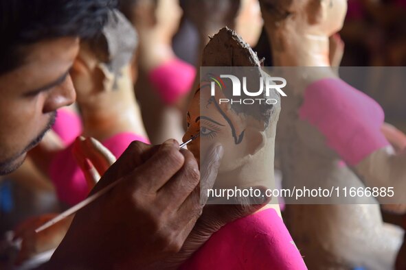 An artist paints an idol of the Hindu Goddess Laxmi at his workshop ahead of the Laxmi Puja in Nagaon District, Assam, India, on October 15,...