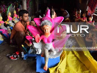 An artist paints an idol of the Hindu Goddess Laxmi at his workshop ahead of the Laxmi Puja in Nagaon District, Assam, India, on October 15,...