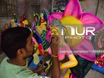 An artist paints an idol of the Hindu Goddess Laxmi at his workshop ahead of the Laxmi Puja in Nagaon District, Assam, India, on October 15,...