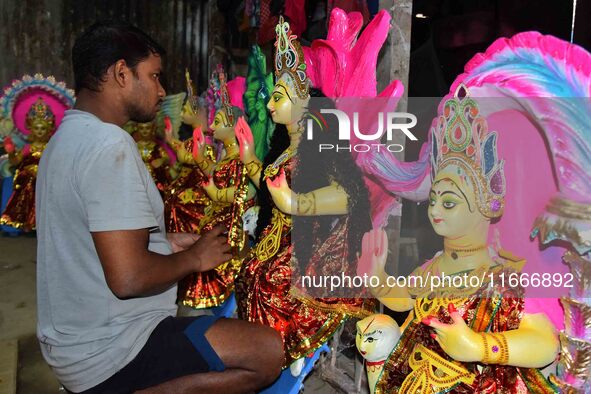 An artist prepares an idol of the Hindu Goddess Laxmi at his workshop ahead of the Laxmi Puja in Nagaon District, Assam, India, on October 1...