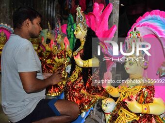 An artist prepares an idol of the Hindu Goddess Laxmi at his workshop ahead of the Laxmi Puja in Nagaon District, Assam, India, on October 1...